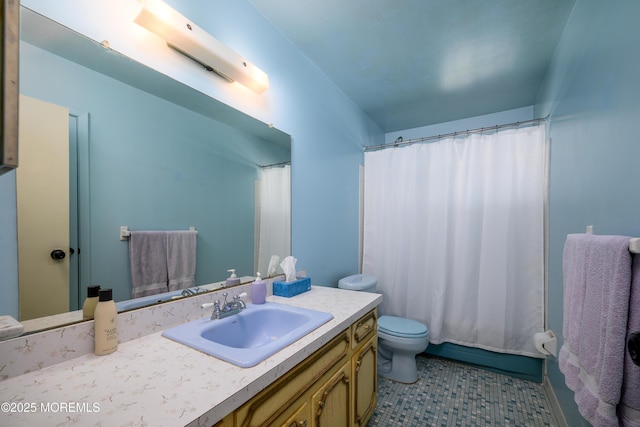 bathroom featuring tile patterned flooring, toilet, and vanity