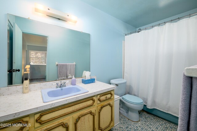 bathroom with toilet, tile patterned floors, vanity, and a shower with shower curtain