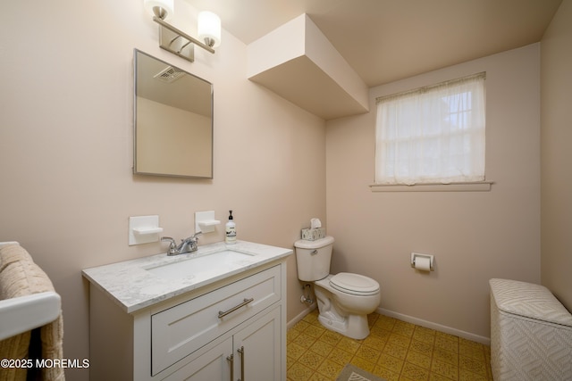 half bath featuring visible vents, baseboards, toilet, vanity, and tile patterned floors