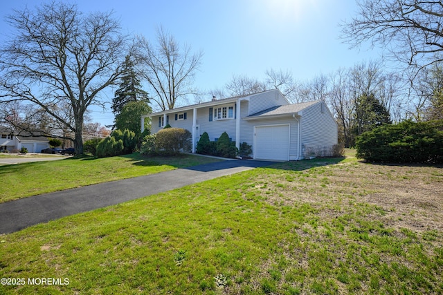 view of front of house featuring a garage, a front yard, and aphalt driveway