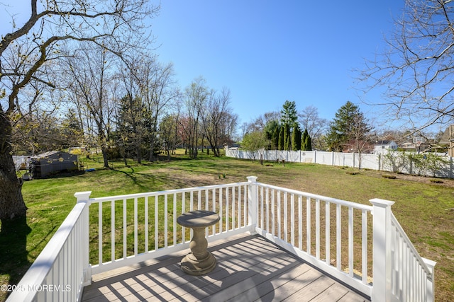 deck with a yard and fence