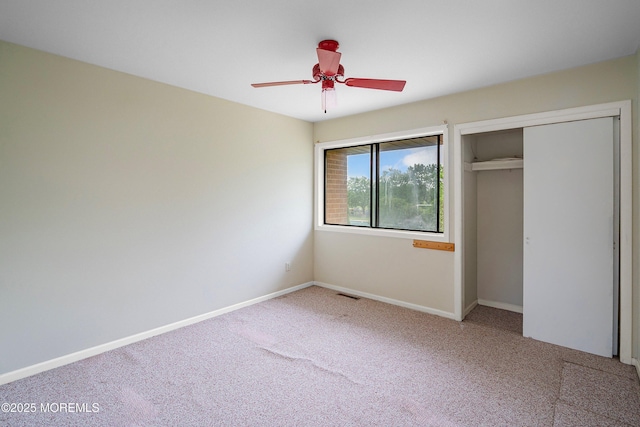 unfurnished bedroom featuring carpet flooring, a closet, baseboards, and ceiling fan