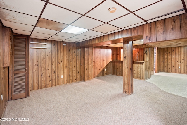 finished below grade area with carpet flooring and wooden walls