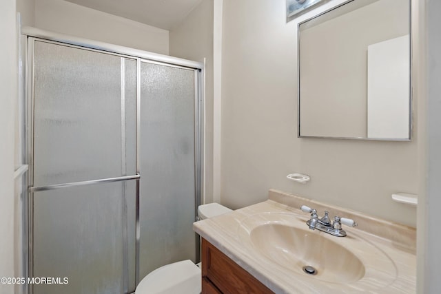 full bathroom with toilet, a shower stall, and vanity