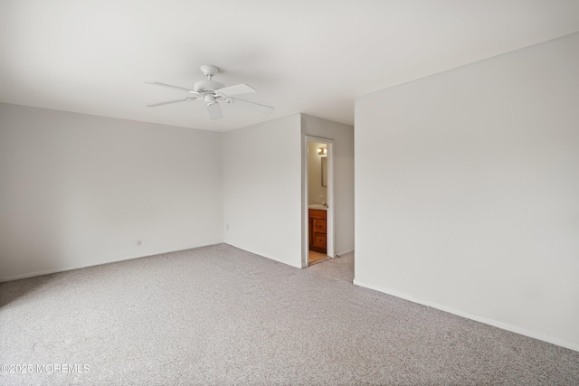 unfurnished room with light carpet, a ceiling fan, and baseboards