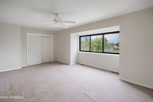 unfurnished bedroom with carpet flooring, a closet, and baseboards
