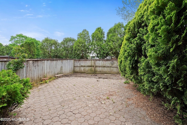 fenced backyard with a patio area