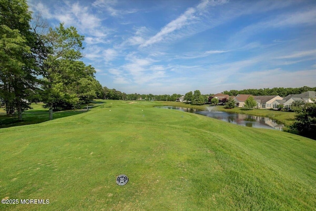view of community with a water view and a lawn