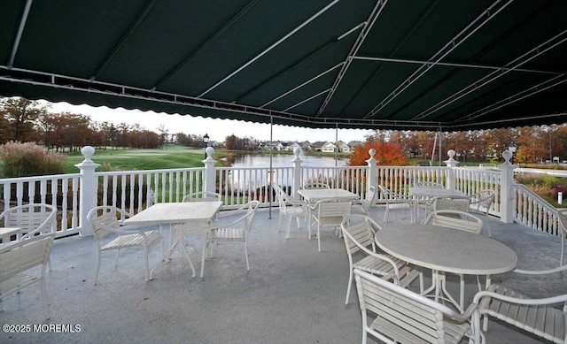 view of patio / terrace with a water view and outdoor dining area