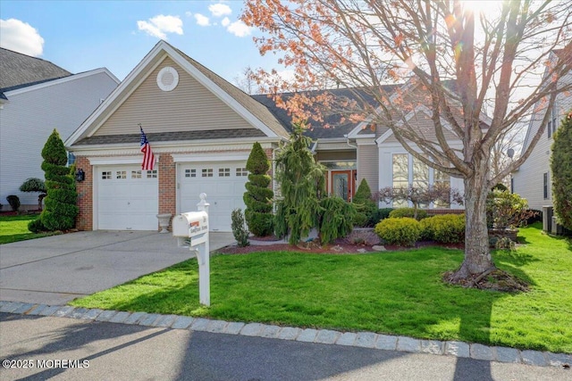 view of front facade with an attached garage, driveway, a front lawn, and brick siding