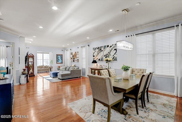 dining space with recessed lighting, light wood-style flooring, baseboards, and ornamental molding
