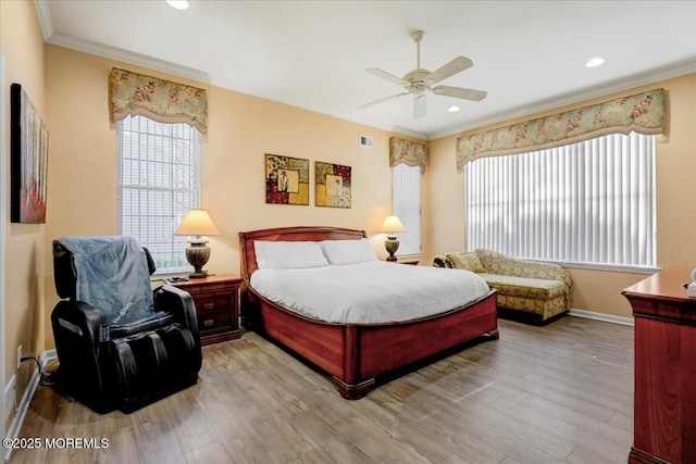 bedroom with ornamental molding, baseboards, recessed lighting, and wood finished floors
