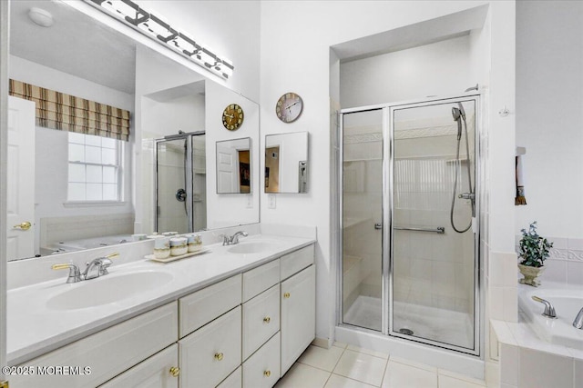 full bath with tile patterned floors, a bath, a sink, and a stall shower