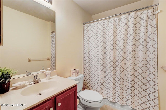 bathroom featuring toilet, vanity, and a shower with curtain