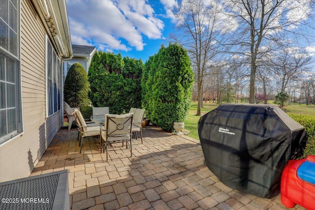 view of patio with a grill and outdoor dining area
