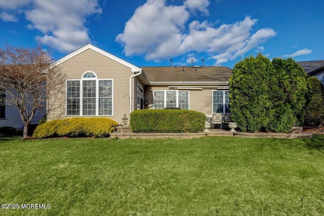 back of house with a yard