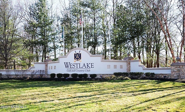 community / neighborhood sign with a yard
