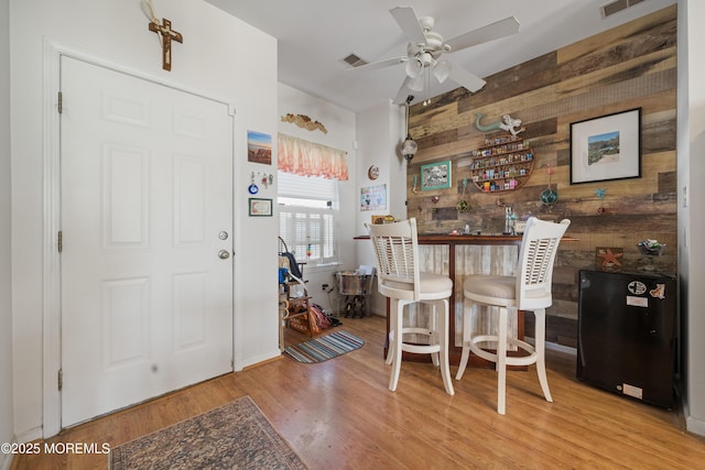 33 Blue Heron Ln, Bayville, NJ 08721 - kitchen with wood walls, freestanding refrigerator, wood finished floors, and ceiling fan