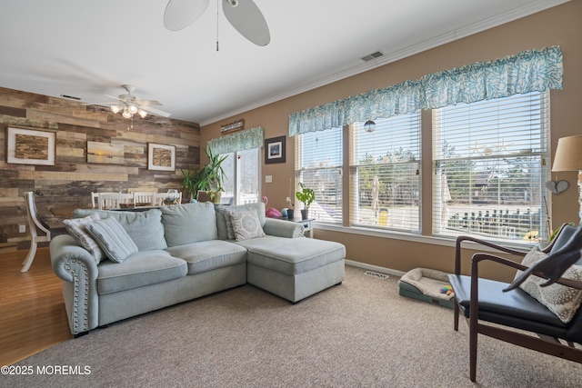 33 Blue Heron Ln, Bayville, NJ 08721 - living room with ceiling fan, wood walls, ornamental molding, and an accent wall