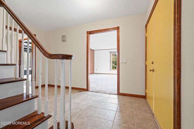 36 New Monmouth Rd, Middletown, NJ 07748 - entrance foyer with stairway, baseboards, light tile patterned floors, and light carpet