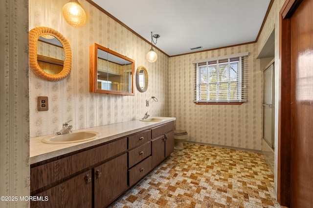 36 New Monmouth Rd, Middletown, NJ 07748 - full bath featuring ornamental molding, wallpapered walls, double vanity, toilet, and an enclosed shower