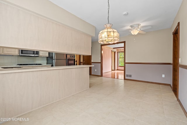 36 New Monmouth Rd, Middletown, NJ 07748 - kitchen with black appliances, a chandelier, light countertops, a ceiling fan, and backsplash