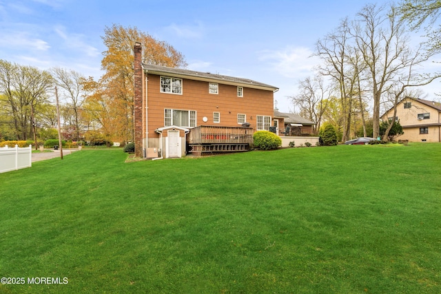 36 New Monmouth Rd, Middletown, NJ 07748 - back of property featuring a deck, a yard, and a chimney