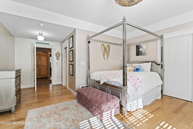 bedroom featuring light wood-style floors, baseboards, and visible vents