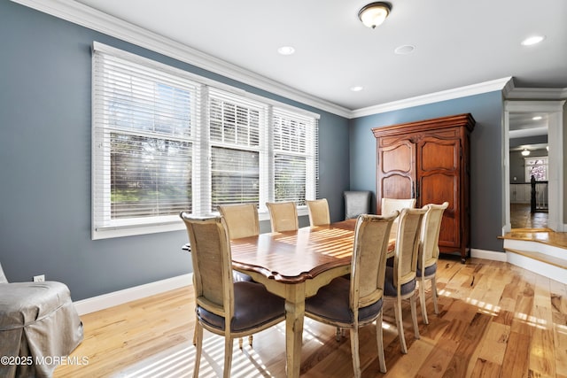 dining area with a wealth of natural light, light wood finished floors, and baseboards