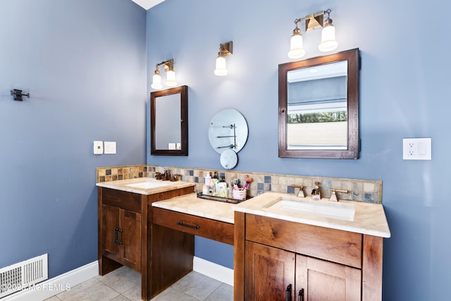 full bath with a sink, visible vents, double vanity, and tile patterned flooring