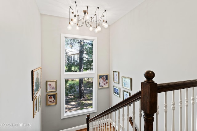 staircase featuring a chandelier