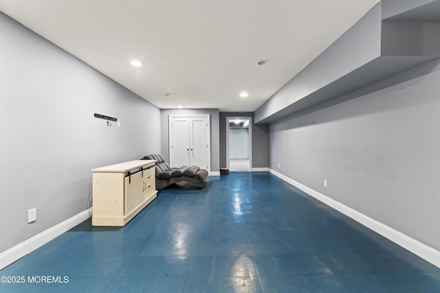 finished basement with baseboards and recessed lighting