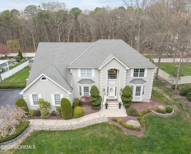 101 Erin Dr, Jackson, NJ 08527 - view of front of home with stucco siding, a front lawn, fence, and a shingled roof