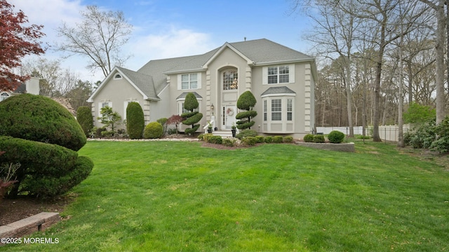 101 Erin Dr, Jackson, NJ 08527 - view of front facade featuring stucco siding, a front lawn, and fence