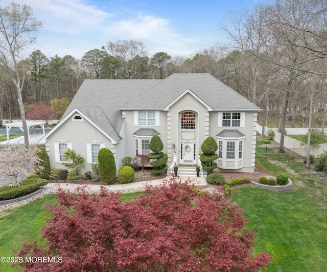 101 Erin Dr, Jackson, NJ 08527 - view of front of house with fence, roof with shingles, a front yard, and stucco siding