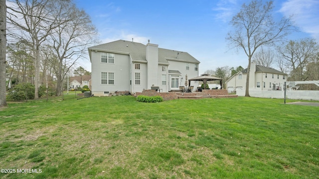 101 Erin Dr, Jackson, NJ 08527 - back of property with a lawn, a gazebo, fence, and a chimney