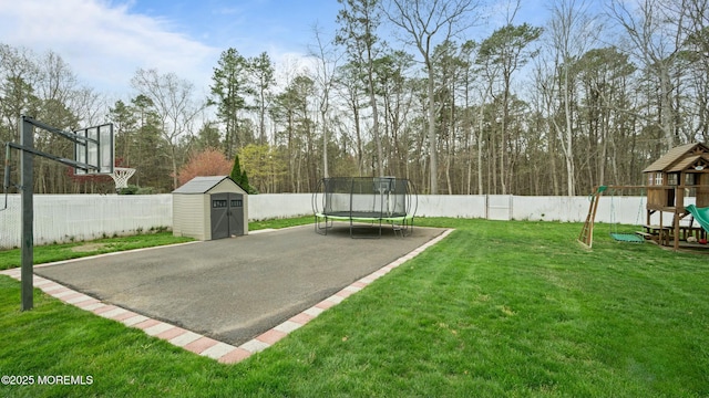 101 Erin Dr, Jackson, NJ 08527 - view of basketball court featuring a storage shed, a trampoline, a fenced backyard, and a playground