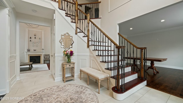 101 Erin Dr, Jackson, NJ 08527 - stairway with recessed lighting, tile patterned floors, a decorative wall, wainscoting, and a fireplace