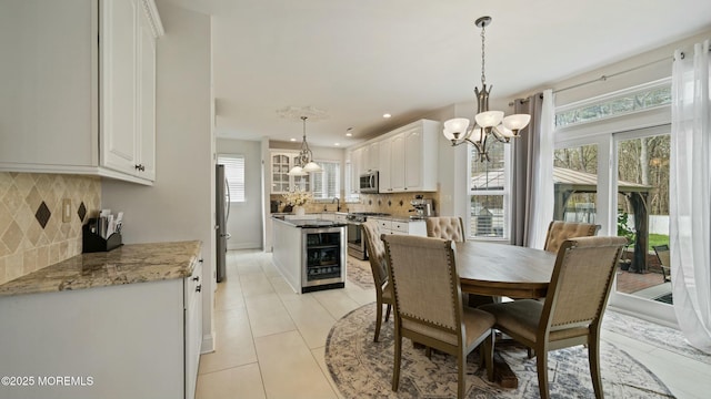 101 Erin Dr, Jackson, NJ 08527 - dining space featuring a healthy amount of sunlight, a chandelier, wine cooler, and light tile patterned floors