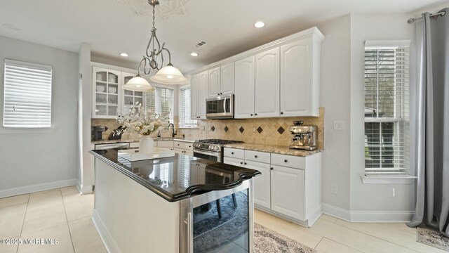 101 Erin Dr, Jackson, NJ 08527 - kitchen with a sink, stainless steel appliances, backsplash, baseboards, and white cabinetry