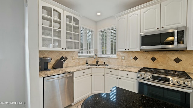101 Erin Dr, Jackson, NJ 08527 - kitchen with stainless steel appliances, light stone counters, a sink, and glass insert cabinets