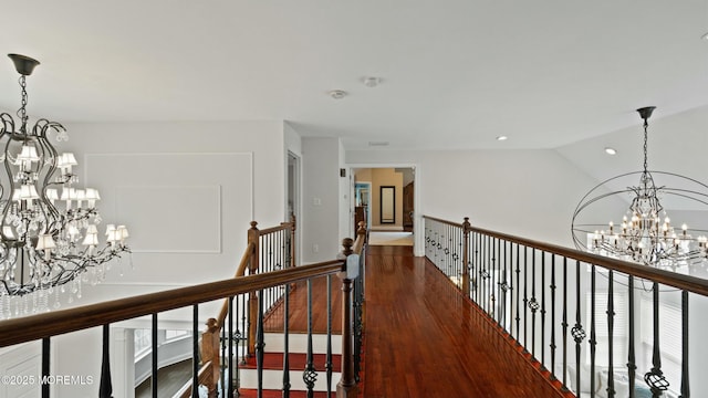 101 Erin Dr, Jackson, NJ 08527 - hall featuring lofted ceiling, wood finished floors, an inviting chandelier, and an upstairs landing