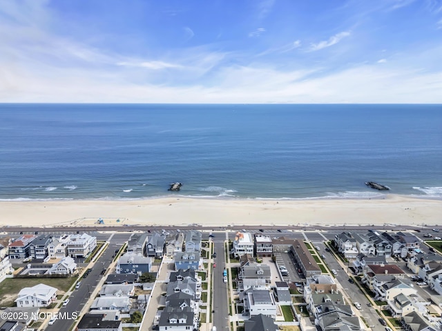 bird's eye view with a water view and a view of the beach