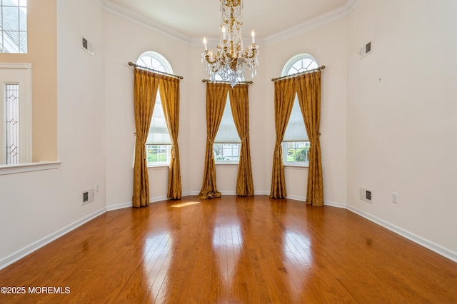 7 Riviera Dr, Monroe, NJ 08831 - unfurnished room with visible vents, wood-type flooring, an inviting chandelier, and plenty of natural light