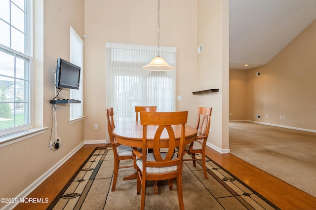 7 Riviera Dr, Monroe, NJ 08831 - dining room featuring wood finished floors, visible vents, a high ceiling, and baseboards