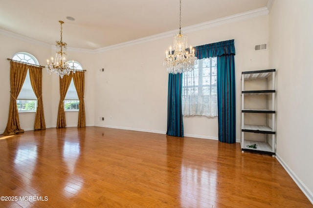 7 Riviera Dr, Monroe, NJ 08831 - spare room featuring a chandelier, wood-type flooring, visible vents, and ornamental molding