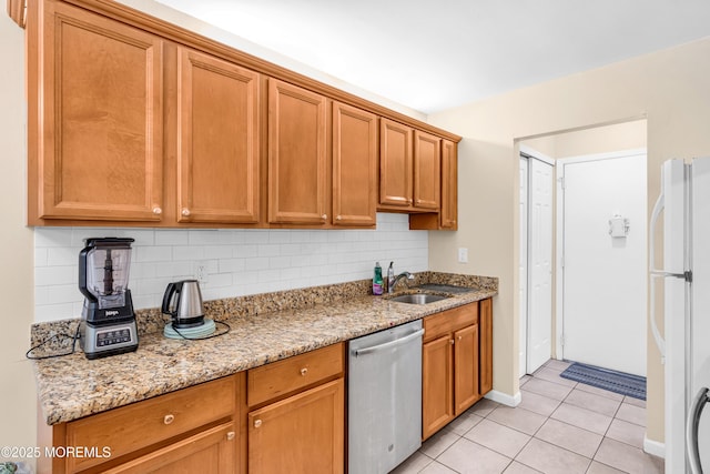 54 Amberly Dr Unit F, Manalapan, NJ 07726 - kitchen featuring light tile patterned floors, a sink, freestanding refrigerator, stainless steel dishwasher, and decorative backsplash