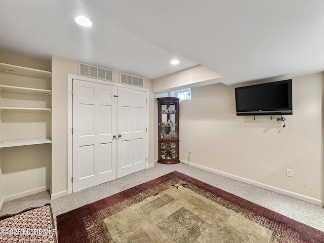 interior space with carpet flooring, baseboards, and visible vents
