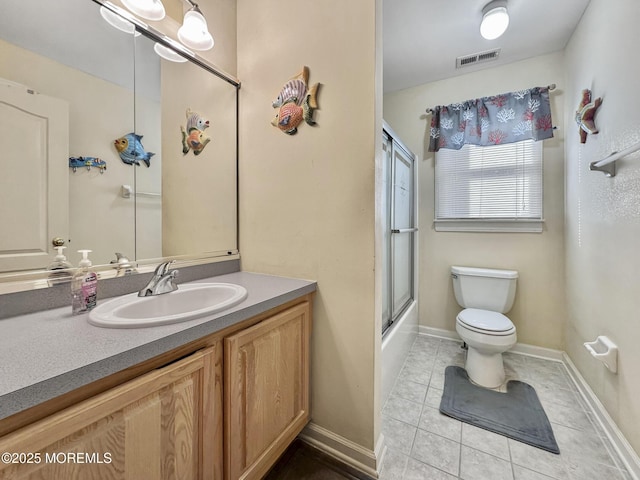 bathroom with vanity, tile patterned flooring, visible vents, toilet, and baseboards