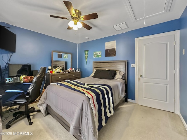 carpeted bedroom featuring ceiling fan, attic access, baseboards, and visible vents